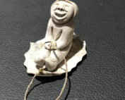 Inuit artist Silas Kayakjuak (Qayaquaq) captures the joy of a child sledding in this sculpture
