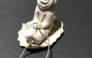 Inuit artist Silas Kayakjuak (Qayaquaq) captures the joy of a child sledding in this sculpture